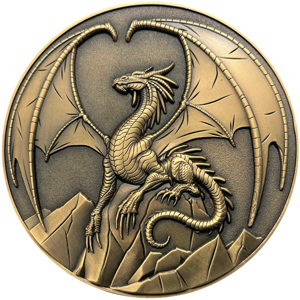 Gold metal coin showing a winged majestic looking dragon on rocks