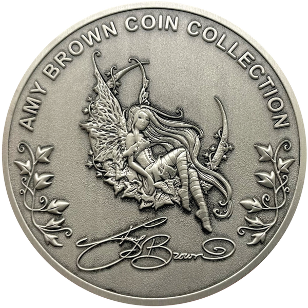 Load image into Gallery viewer, Silver metal coin showing fairy, leaves, and words Amy Brown Coin Collection
