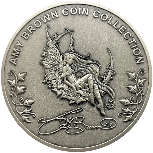 Load image into Gallery viewer, Silver metal coin showing fairy, leaves, and words Amy Brown Coin Collection