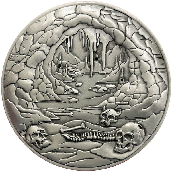 Load image into Gallery viewer, Silver metal coin showing bones and cave entrance