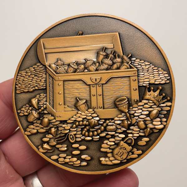 Load image into Gallery viewer, Copper metal coin in hand with acorns, treasure, and treasure chest