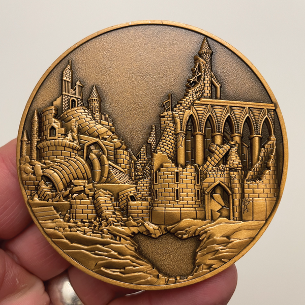 Load image into Gallery viewer, Copper metal coin in hand showing city in ruins