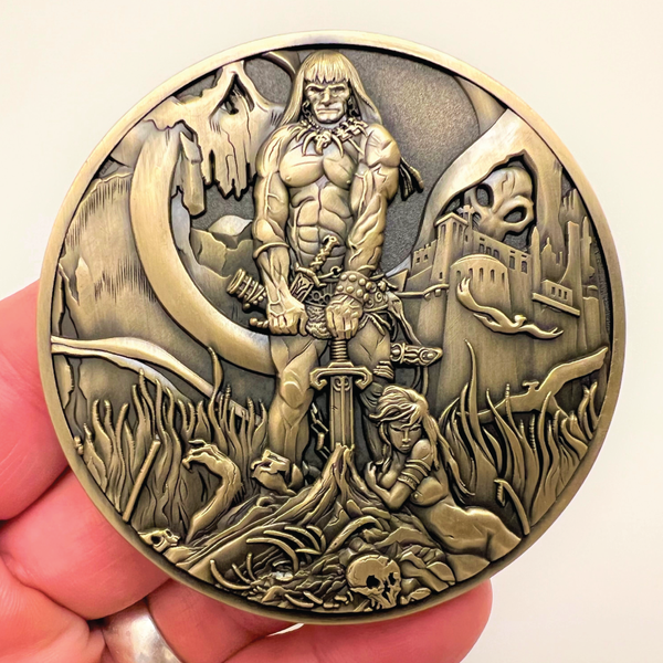 Load image into Gallery viewer, Gold metal coin in hand showing Barbarian coin
