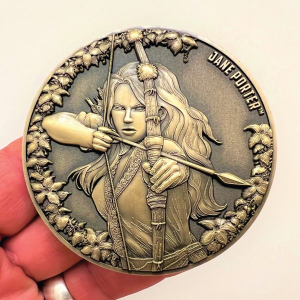 Load image into Gallery viewer, Metal display coin in hand showing Jane Porter
