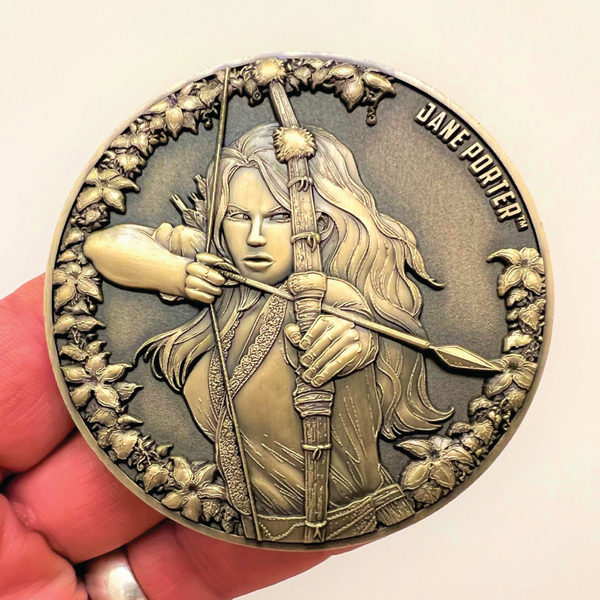 Load image into Gallery viewer, Metal display coin in hand showing Jane Porter