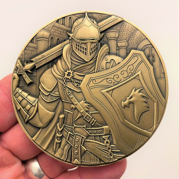 Load image into Gallery viewer, Gold metal coin in hand showing Paladin in castle