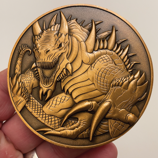 Load image into Gallery viewer, Copper metal coin in hand showing Tarrasque