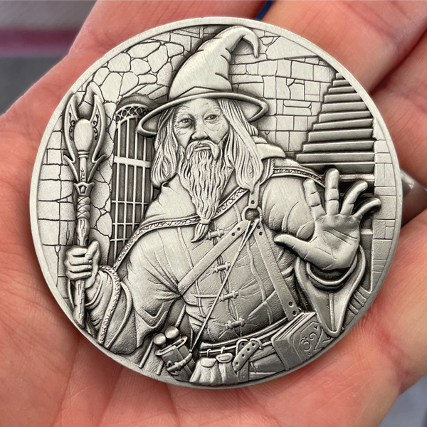 Load image into Gallery viewer, Silver painted coin in hand showing wizard