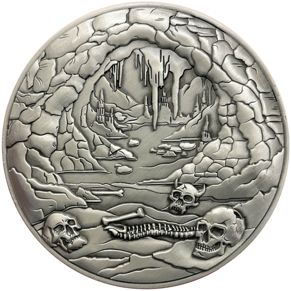 Load image into Gallery viewer, Silver metal coin showing bones and cave entrance
