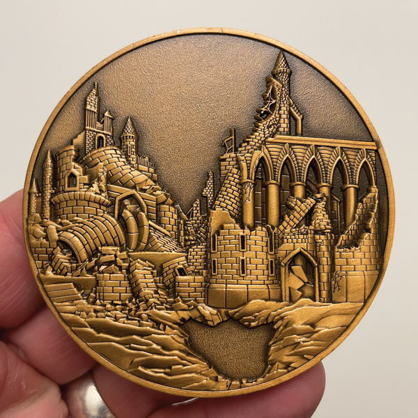 Load image into Gallery viewer, Copper metal coin in hand showing city in ruins
