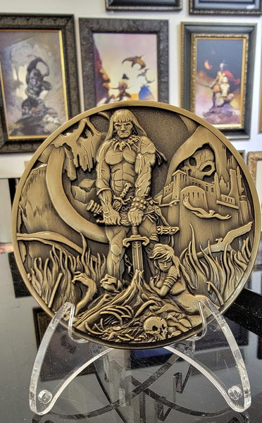 Load image into Gallery viewer, Barbarian coin on stand at Frazetta museum

