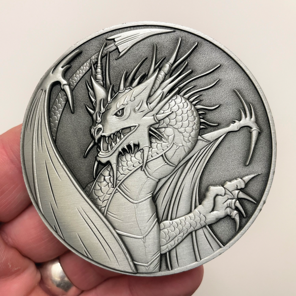 Load image into Gallery viewer, Silver metal coin with dragon held in hand
