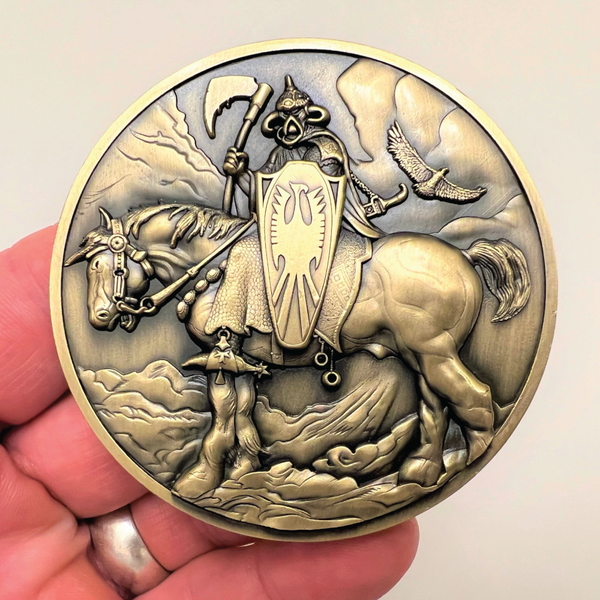 Load image into Gallery viewer, Gold metal coin in hand showing Death Dealer
