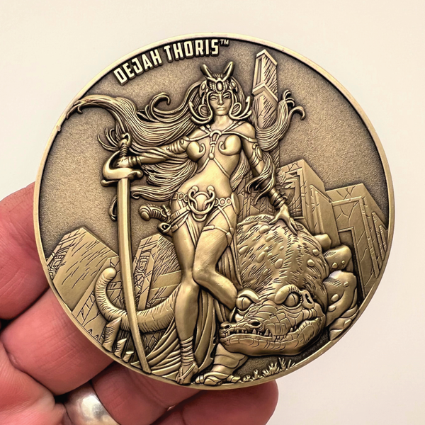 Load image into Gallery viewer, Gold metal coin in hand showing Dejah Thoris coin
