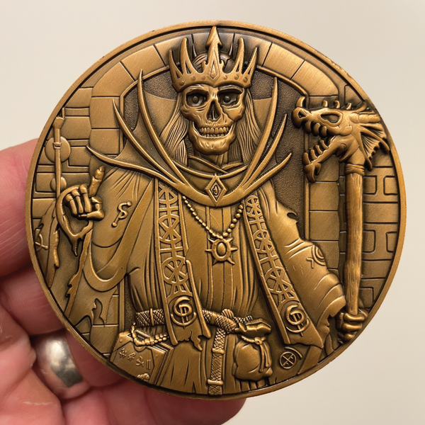 Load image into Gallery viewer, Copper metal coin in hand showing Lich
