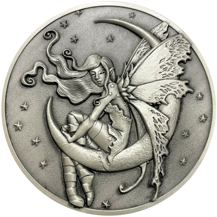 Silver metal coin showing fairy sitting on moon