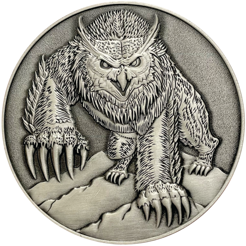 Silver metal coin showing Owlbear