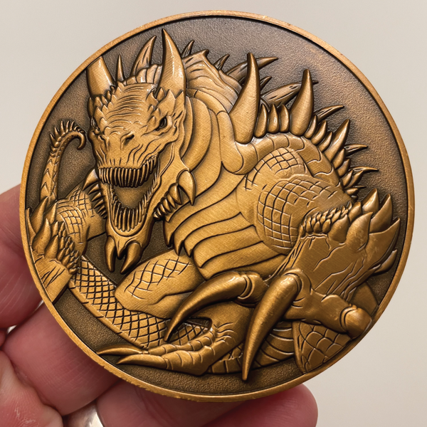 Load image into Gallery viewer, Copper metal coin in hand showing Tarrasque

