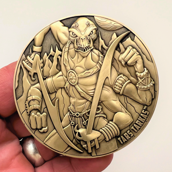 Load image into Gallery viewer, Gold metal coin in hand showing Tar Tarkas
