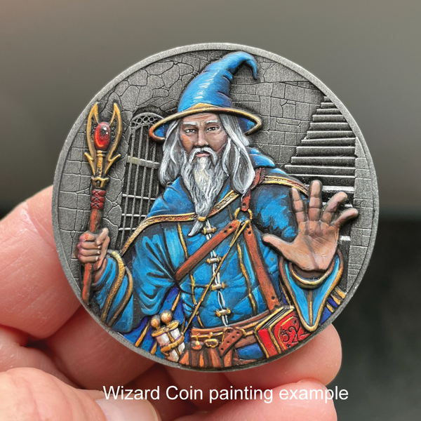 Load image into Gallery viewer, Silver metal coin with painted wizard, blue clothing, white beard, held in hand
